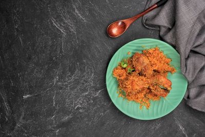 Ayam serundeng, fried chicken with shredded coconut. top view, 