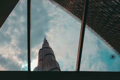 Low angle view of glass building against sky