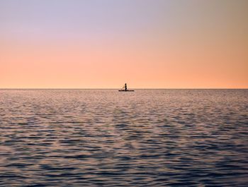 Waterboarding during early morning sunrise on lake ontario along burlington beach in ontario, canada