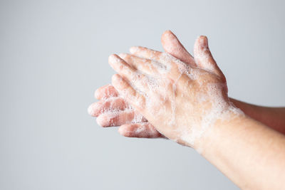 Close-up of hand against white background