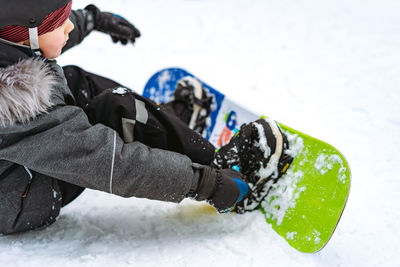 Low section of woman holding snow