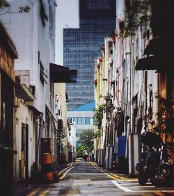 Street amidst buildings in city against sky