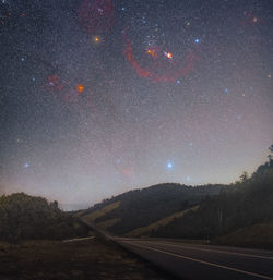 Scenic view of landscape against sky at night