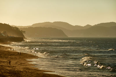 Scenic view of sea against clear sky during sunrise