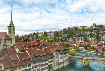 High angle view of buildings against cloudy sky