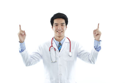 Portrait of smiling man standing against white background