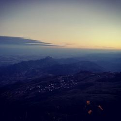 Aerial view of city by sea against sky