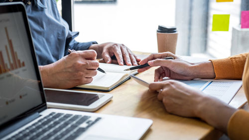 Midsection of business colleagues working at office