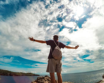 Full length of man standing on beach against sky