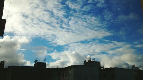 Low angle view of building against cloudy sky