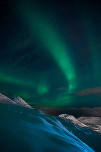 Scenic view of landscape against sky at night