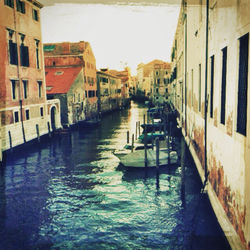Boats in canal with buildings in background
