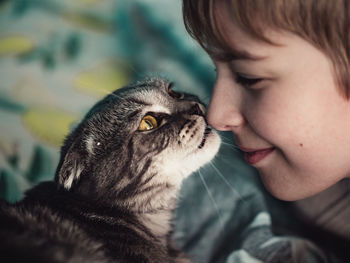 Close-up of cat looking to the boy with love