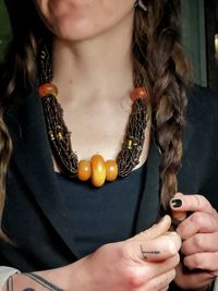 Close-up of woman with amber necklace etsy selling 