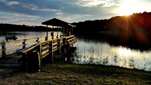 Pier over lake during sunset