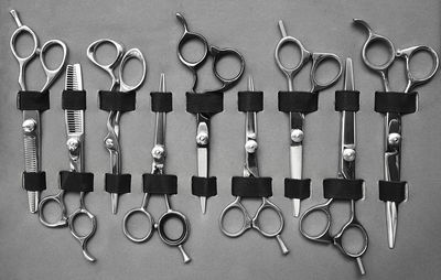 High angle view of scissors against gray background