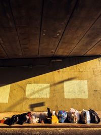 High angle view of garbage against wall at alley