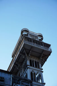 Low angle view of building against clear blue sky