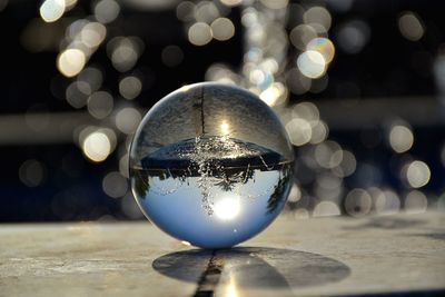 Close-up of illuminated crystal ball on table