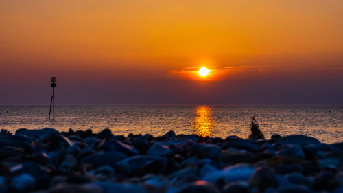 Scenic view of sea against sky during sunset