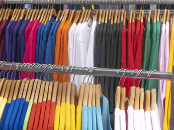 Colorful clothes hanging in rack for sale