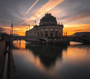 Bridge over river during sunset