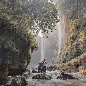 Scenic view of waterfall against rocks