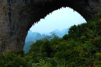 Scenic view of mountains seen through arch