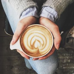 Midsection of woman holding coffee cup