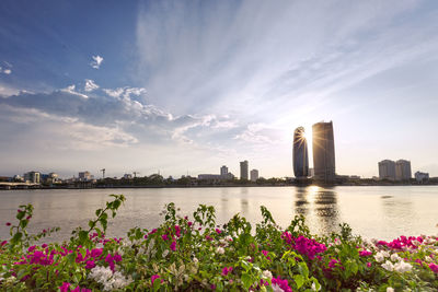 Scenic view of river against cloudy sky