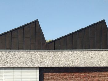 Low angle view of buildings against clear blue sky