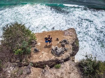 High angle view of couple walking at beach