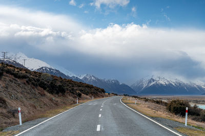 Mount cook road alongside lake pukaki with snow capped southern alps in winter evening light. 