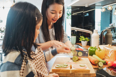 Young woman preparing food on cutting board