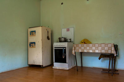 Old wooden table against wall at home