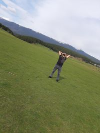 Full length of man standing on field against sky