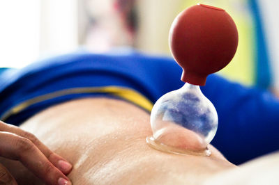 Close-up of hand holding balloons