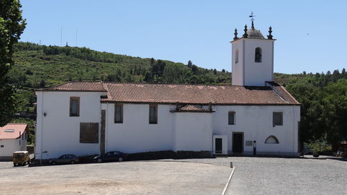 Exterior of house by building against sky