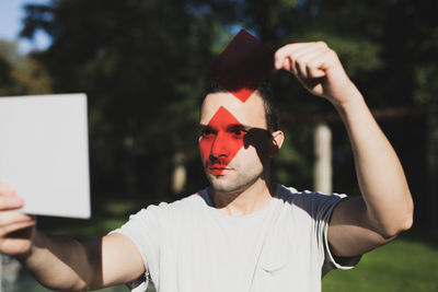 Young man with red reflection on eyes