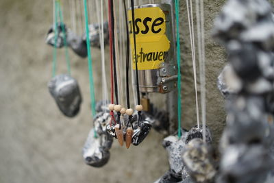 Close-up of information sign hanging on metal pole