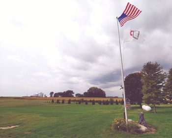 Flag on field against sky