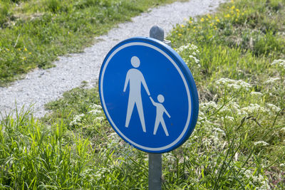 Close-up of road sign on grass