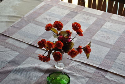 High angle view of red flower vase on table