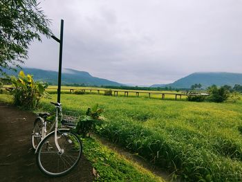 Bicycle on field against sky