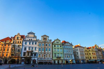 Residential buildings against clear blue sky