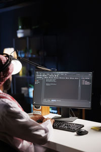 Midsection of man using laptop at office