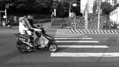 Scooty at zebra crossing on road