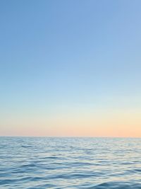 Scenic view of sea against clear sky during sunset