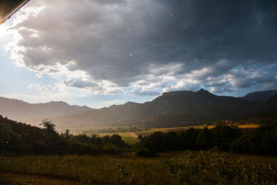 Scenic view of landscape and mountains against sky