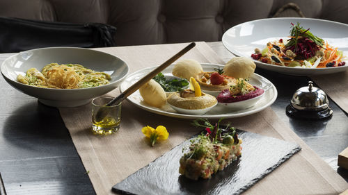 Food served in bowls and plates on table